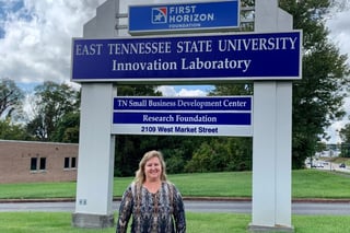 Debbie Smith in front of the Innovation Lab sign.